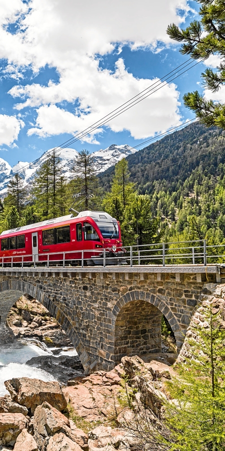 A train of the Rhaetian Railway crosses one of the many bridges in Engadin