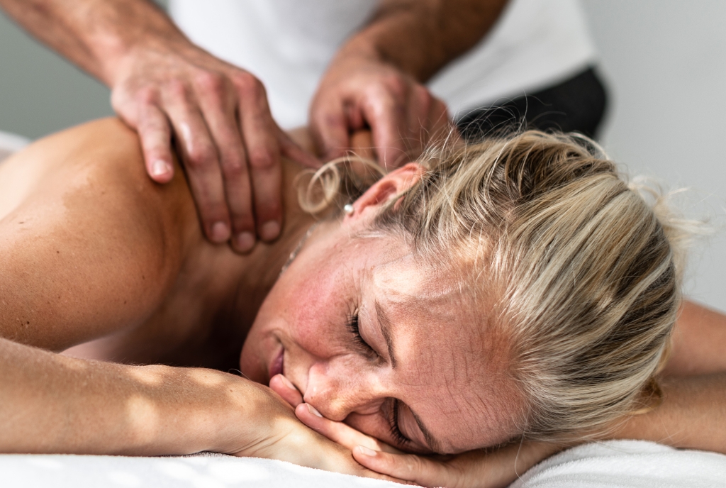 A therapist massages the back of a client A therapist massages the back of a client