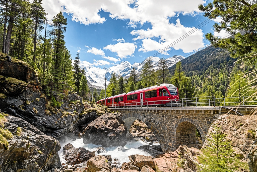 A train of the Rhaetian Railway crosses one of the many bridges in Engadin