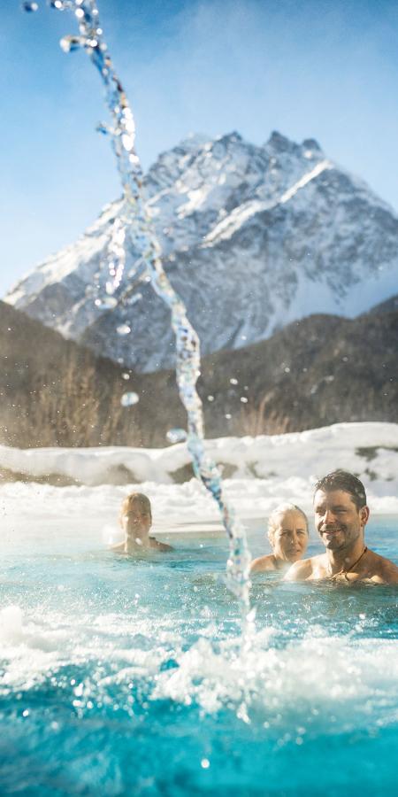 Bathers in the panoramic outdoor pool at Bogn Engiadin Scuol