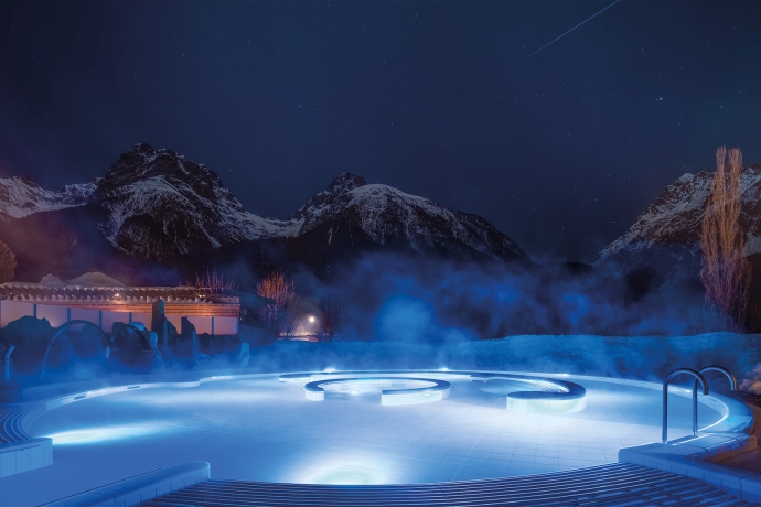 Stimmungsvoller Blick auf das beleuchtete Aussenbecken des Bogn Engiadina in Scuol im Winter Stimmungsvoller Blick auf das beleuchtete Aussenbecken des Bogn Engiadina in Scuol im Winter
